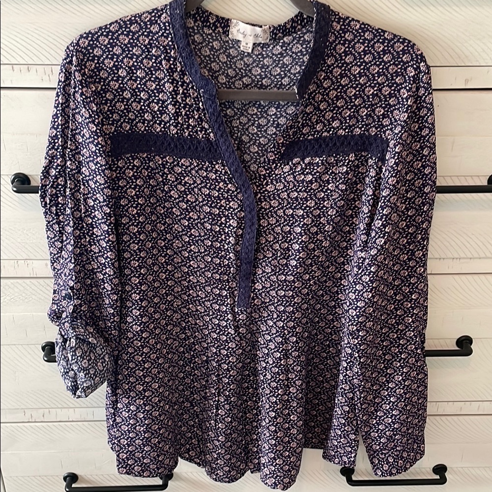 Bailey + Chloe relaxed tunic with roll tab sleeves. Embroidered detail.